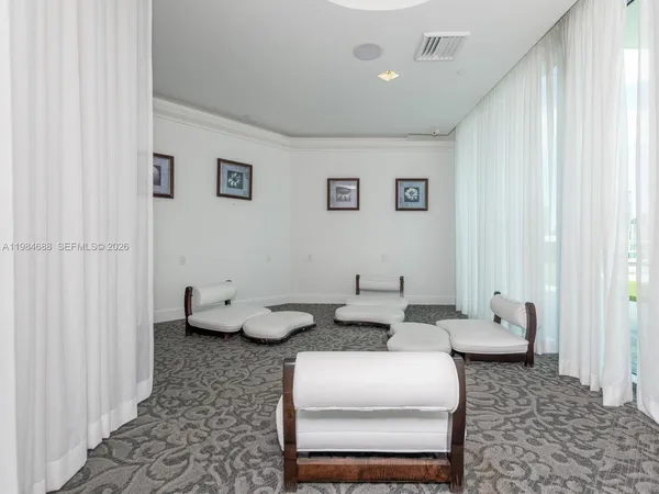 a view of a livingroom with furniture and a ceiling fan