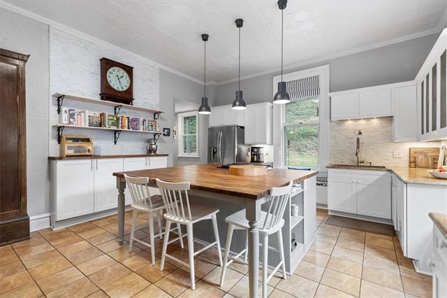 a kitchen with stainless steel appliances granite countertop a stove a sink and a refrigerator