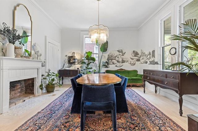 a dining room with furniture a rug and a chandelier