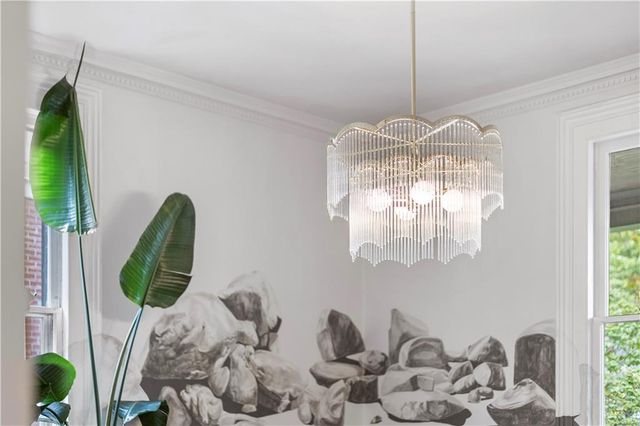 a room with furniture a rug and white walls