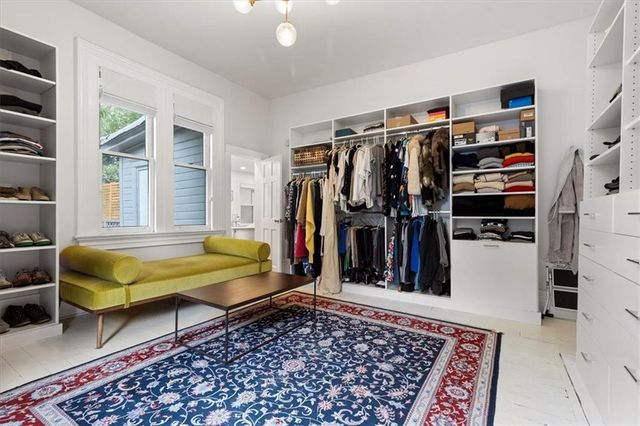 a spacious bathroom with a sink a toilet and a mirror