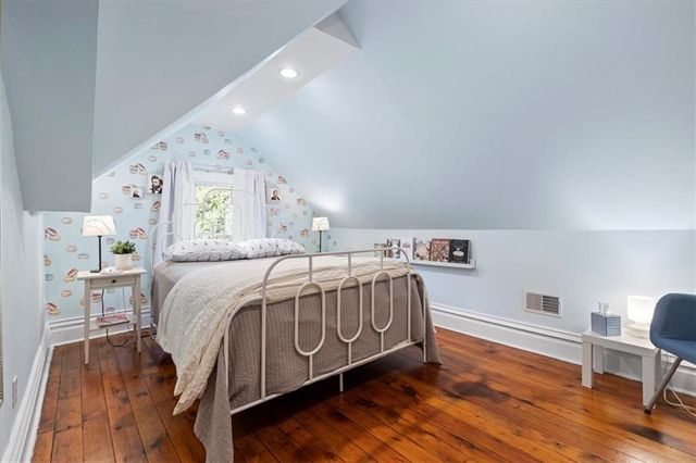 a bedroom with two beds and a chandelier