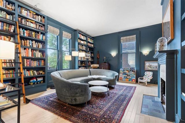 a living room with furniture and a book shelf