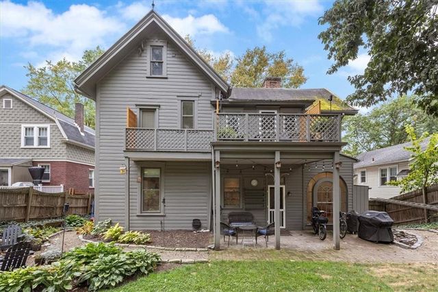 an aerial view of residential houses with outdoor space and trees