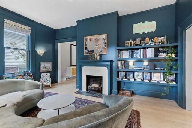 a living room with furniture and a fireplace