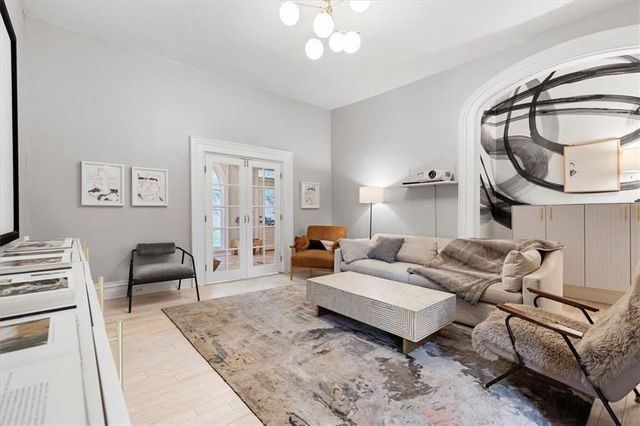 a living room with furniture and a chandelier