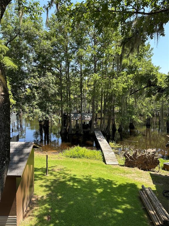 1366 United Gas Road Ringgold, LA 71068 - Photo 17 of 19 View of green lawn with a water view and a dock