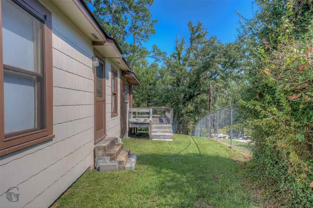 1366 United Gas Road Ringgold, LA 71068 - Photo 4 of 19 View of yard with a wooden deck and view of wooded area