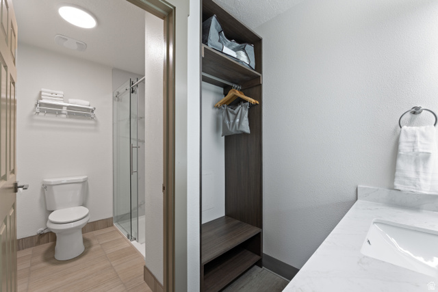 245 Red Cliffs Drive, Unit 104 St. George, UT 84790 - Photo 11 of 33 Full bathroom with a stall shower and vanity