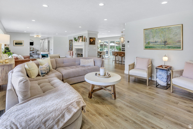 1350 Canyon Park Road Bountiful, UT 84010 - Photo 7 of 38 Open-concept living area featuring wood-finish flooring, recessed lighting, and a white fireplace surround