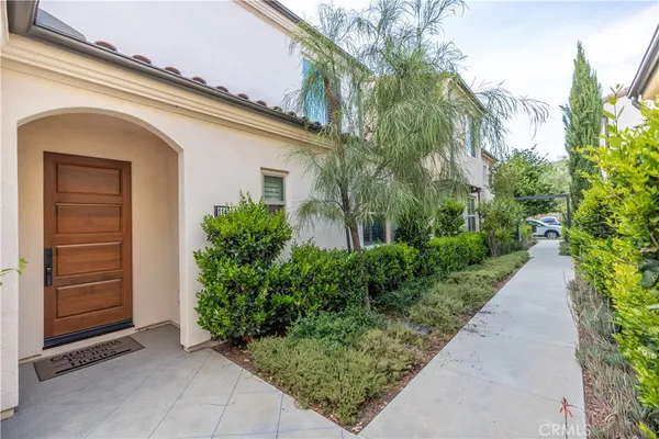a couple of potted plants in front of door
