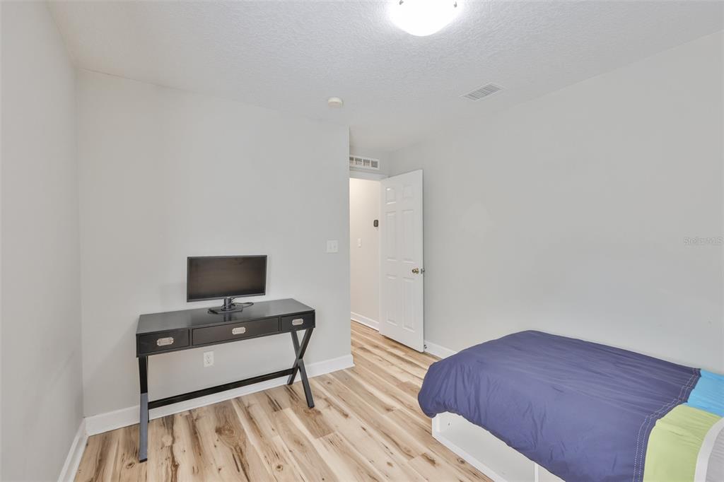 2331 West Chestnut Street Tampa, FL 33607 - Photo 21 of 33 a bedroom with a bed and a television