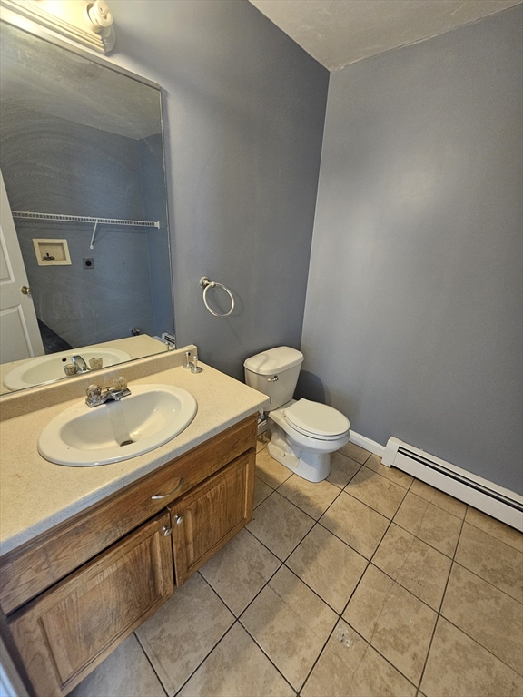 40 Merrick Street, Unit A Worcester, MA 01609 - Photo 11 of 32 a bathroom with a sink a toilet and mirror