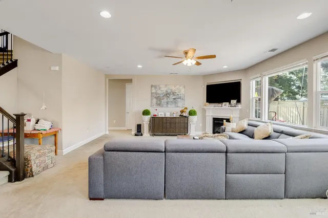 a living room with furniture a fireplace and a flat screen tv