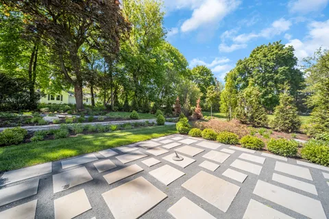 a view of backyard with swimming pool and green space