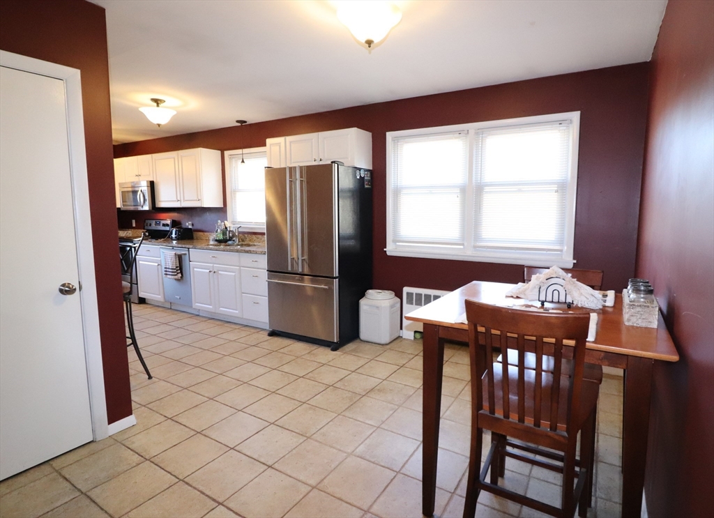 36 Stony Brook Road Raynham, MA 02767 - Photo 11 of 30 a kitchen with refrigerator cabinets and wooden floor