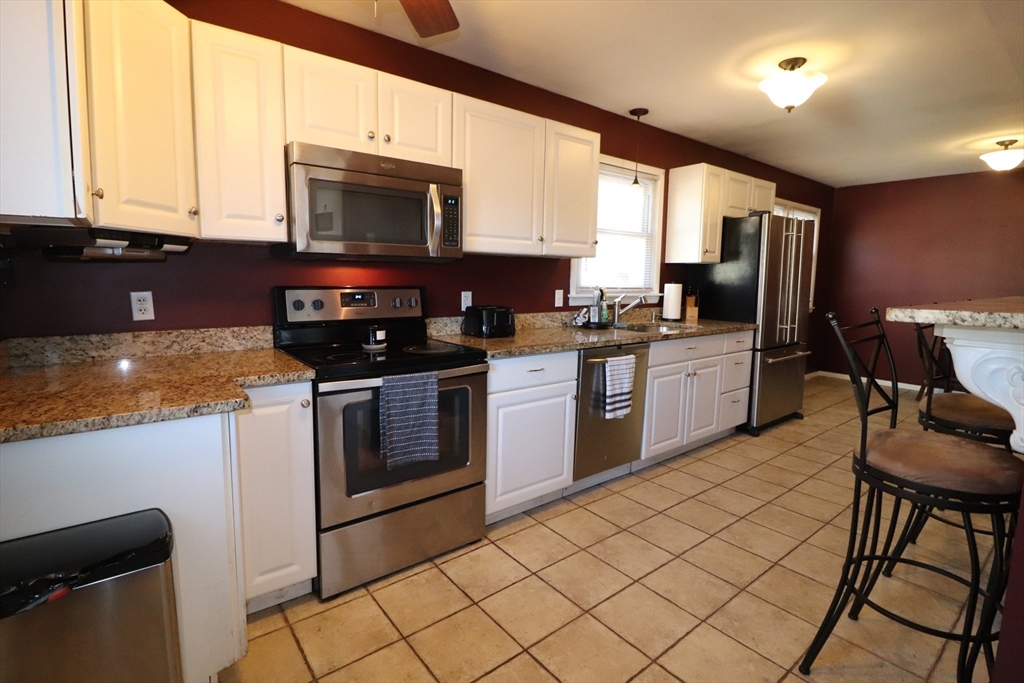 36 Stony Brook Road Raynham, MA 02767 - Photo 7 of 30 a kitchen with stainless steel appliances granite countertop a stove a sink and a microwave