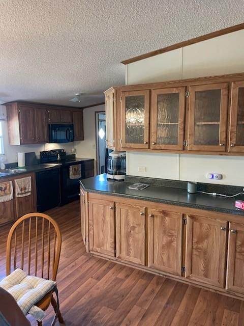 1001 Elizabeth Coleman, TX 76834 - Photo 16 of 32 a kitchen with granite countertop a sink cabinets and wooden floor