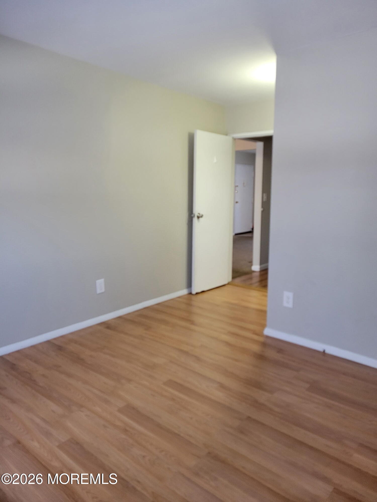 400 Matawan Avenue, Unit 57B Cliffwood, NJ 07721 - Photo 5 of 7 a view of an empty room with wooden floor