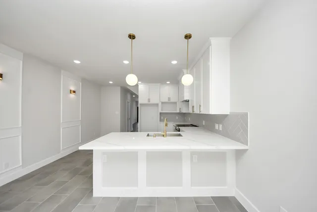 a view of a sink a mirror and cabinets