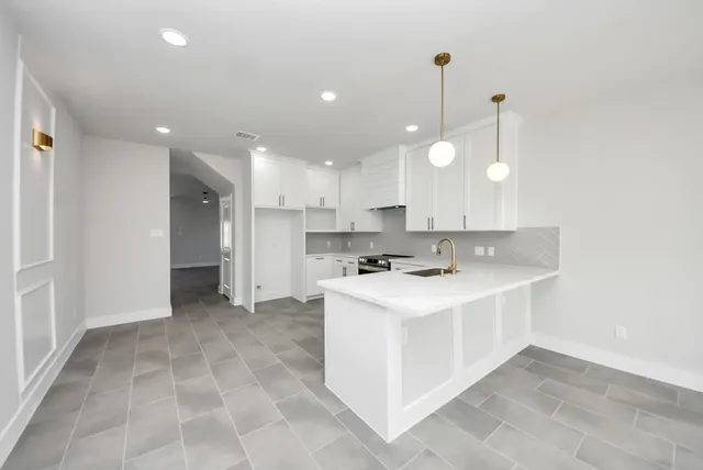 a kitchen with kitchen island a sink stainless steel appliances and cabinets