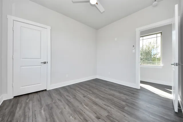 a bathroom with a granite countertop sink a toilet and bathtub