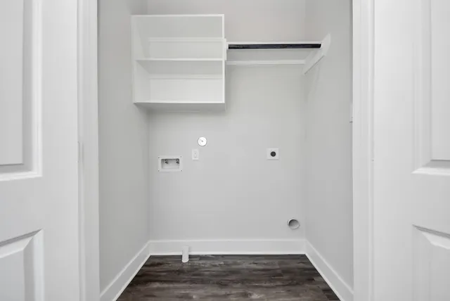 an empty room with wooden floor and a ceiling fan