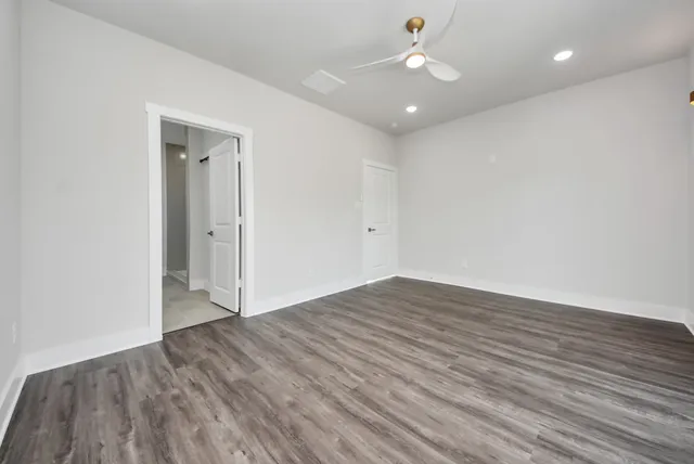 a bathroom with a granite countertop sink a toilet and a large mirror