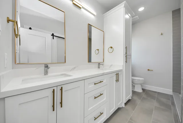 a bathroom with a double vanity sink and a mirror