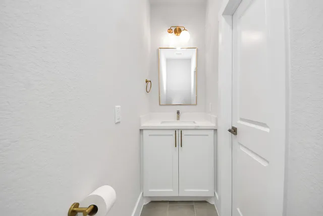 a bathroom with a sink a toilet and mirror