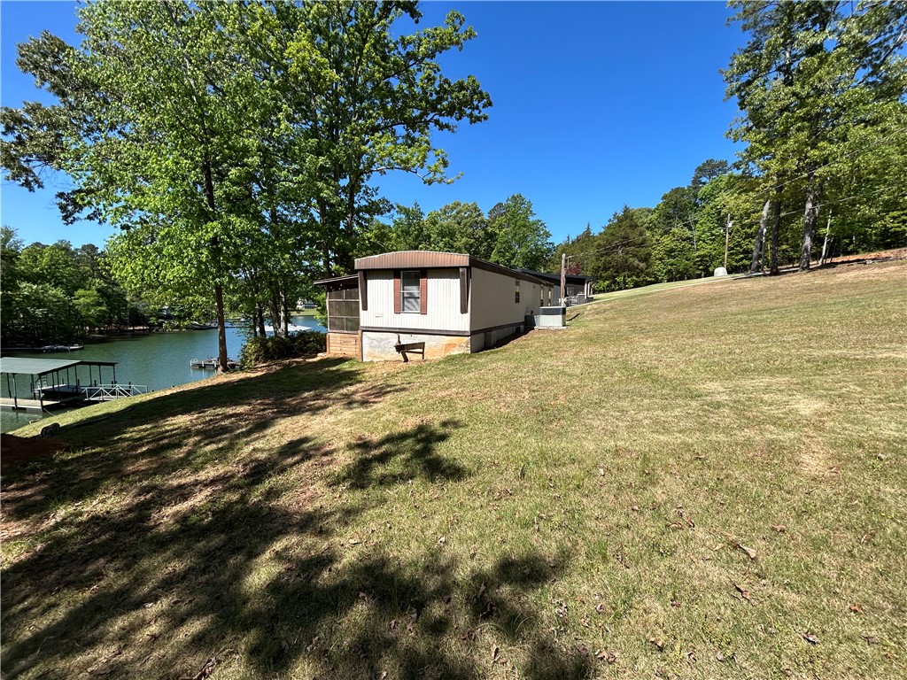 43 Sunset Cove Road Abbeville, SC 29620 - Photo 39 of 41 This charming lakeside retreat features a sprawling yard and serene water views, perfect for outdoor living.