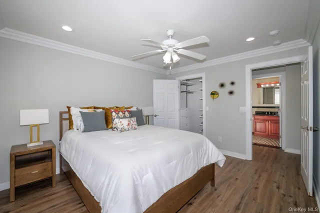 a bedroom with bed and a chandelier
