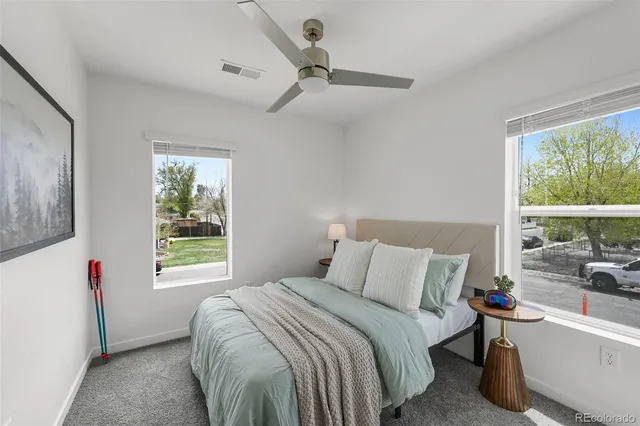 a bedroom with a bed and a large window