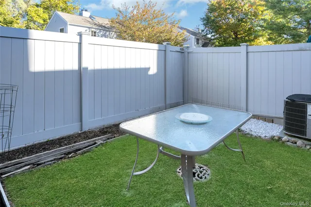 a view of a backyard with a table and chairs