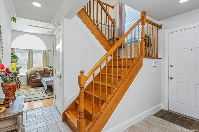 a living room with wooden floor and stairs