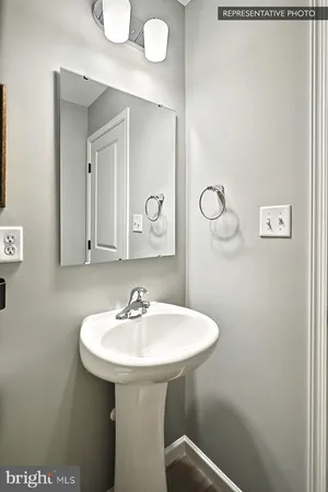 a bathroom with a sink a mirror and shower