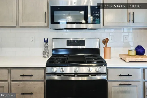 a stove top oven sitting inside of a kitchen