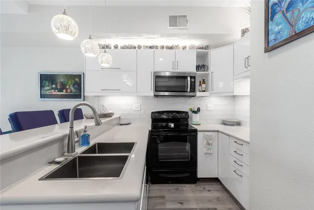 a kitchen with granite countertop cabinets and steel stainless steel appliances