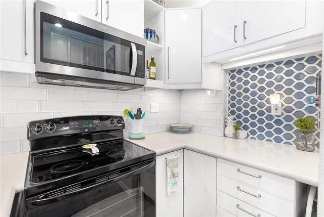 a kitchen with stainless steel appliances kitchen island a refrigerator and a sink