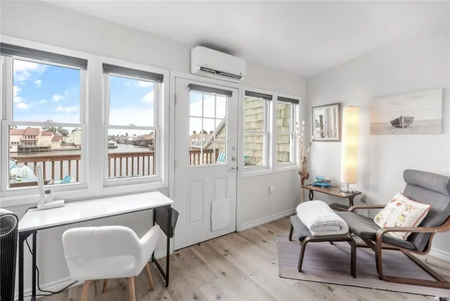 a view of a dining room with furniture windows and wooden floor
