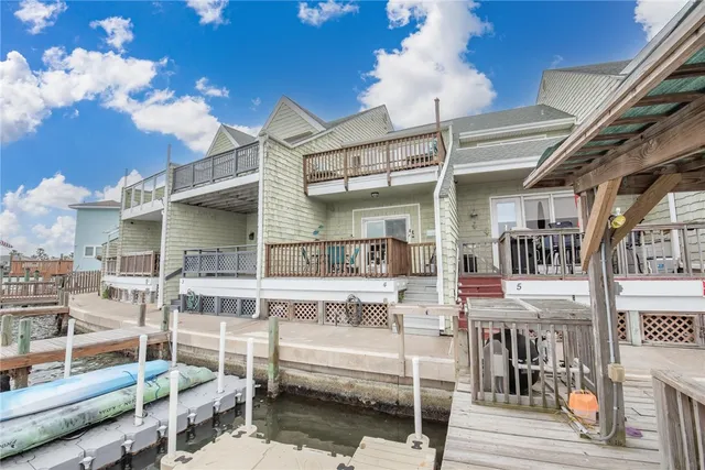 a view of entryway with a floor to ceiling window stairs and a wooden floor