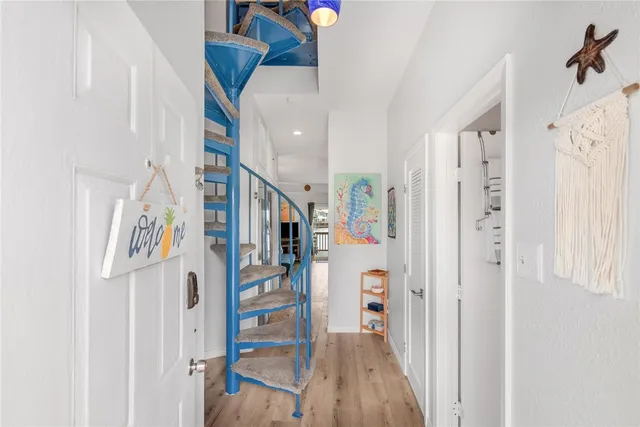 a view of entryway and hall with wooden floor