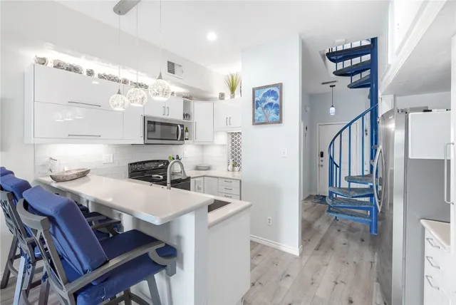 a kitchen with a sink stove and microwave