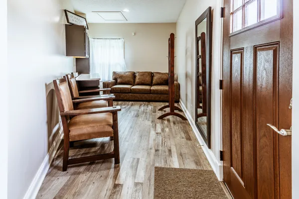 a living room with furniture a book shelf and a book shelf