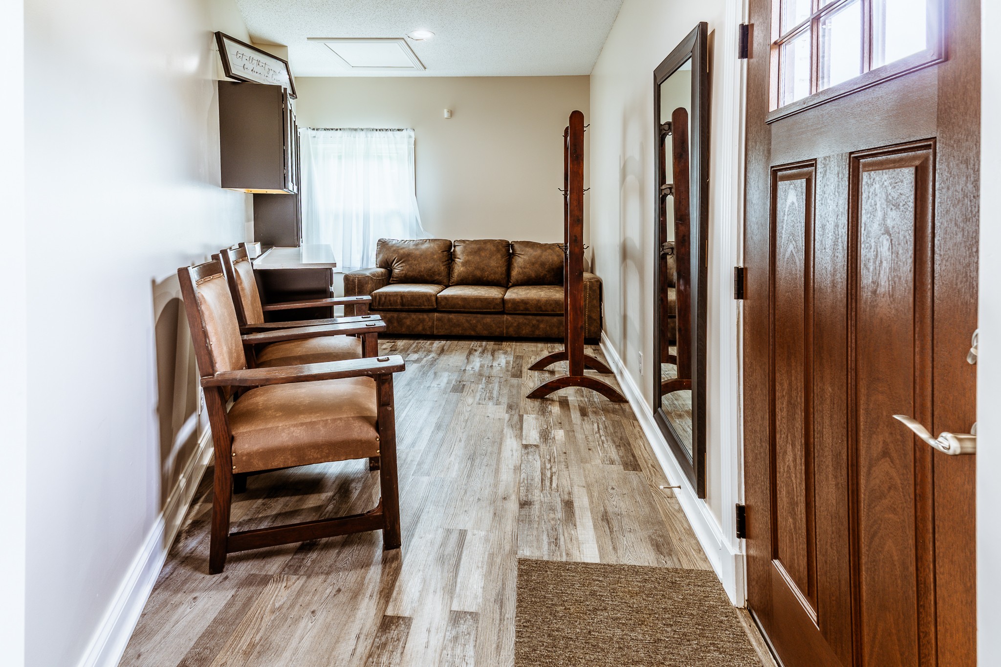 3375 Rowland Mill Road Buena Vista, TN 38318 - Photo 12 of 85 a hallway with a couch and a dining table next to a window