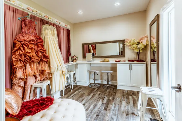 a bedroom with furniture a flat screen tv and a window