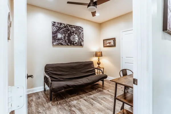 a bedroom with a bed and wooden floor