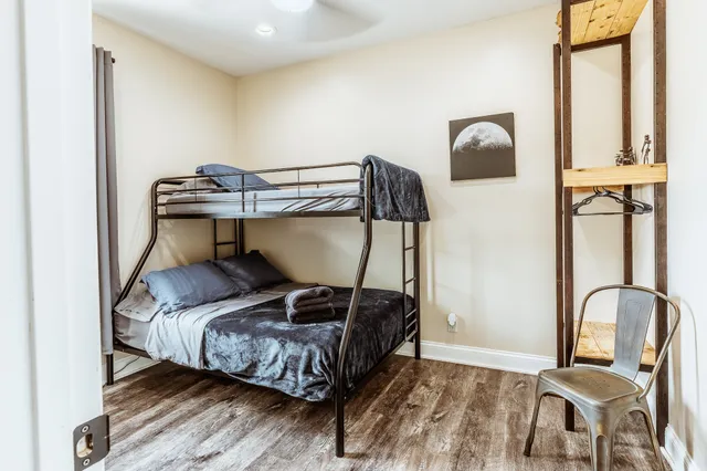 a living room with furniture a kitchen view and a refrigerator