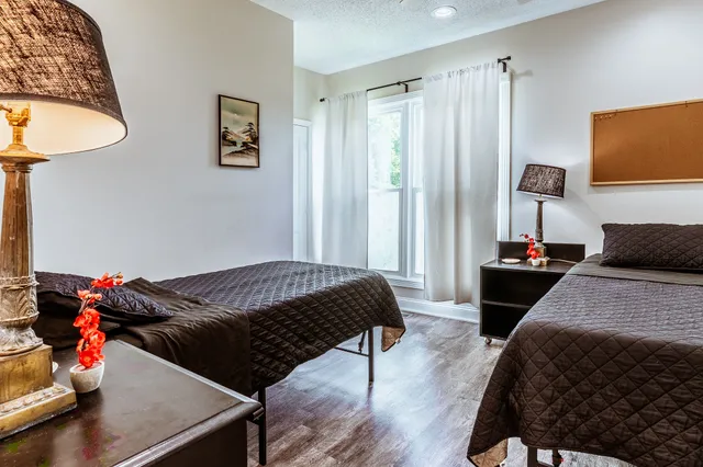 a view of a house with a yard and a fountain