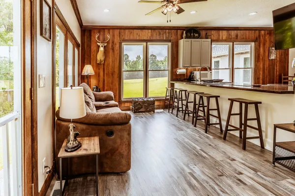 a view of pool with lake and trees in the background